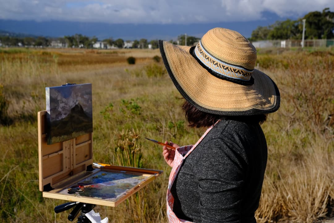 Painting outdoors at a field easel